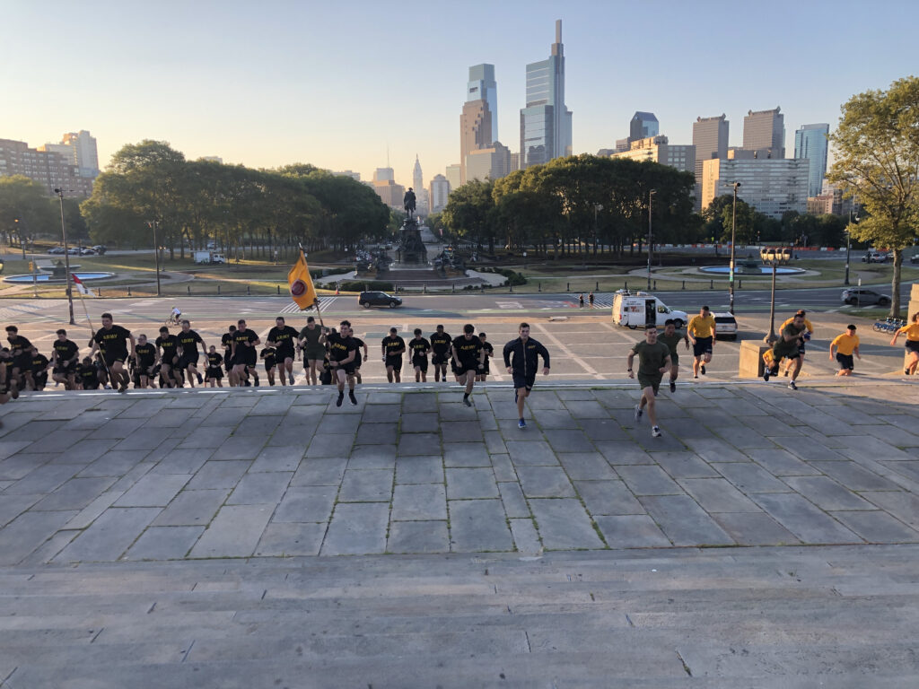 ROTC Midshipmen and Cadets racing to the top of the steps