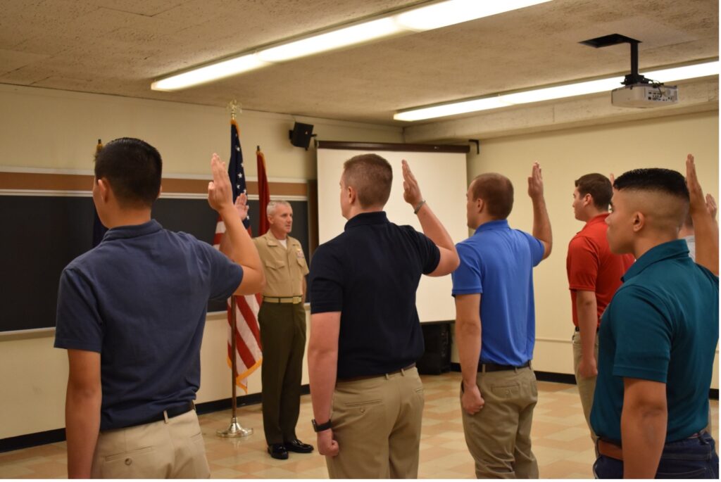 Kilo Company midshipmen raising their right hand and reciting the Oath of Office
