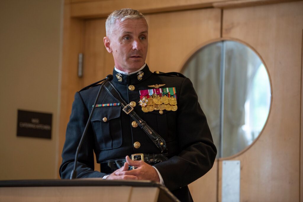 Commanding Officer and Professor of Naval Science Colonel Vincent J. Ciuccoli offers his remarks from a podium